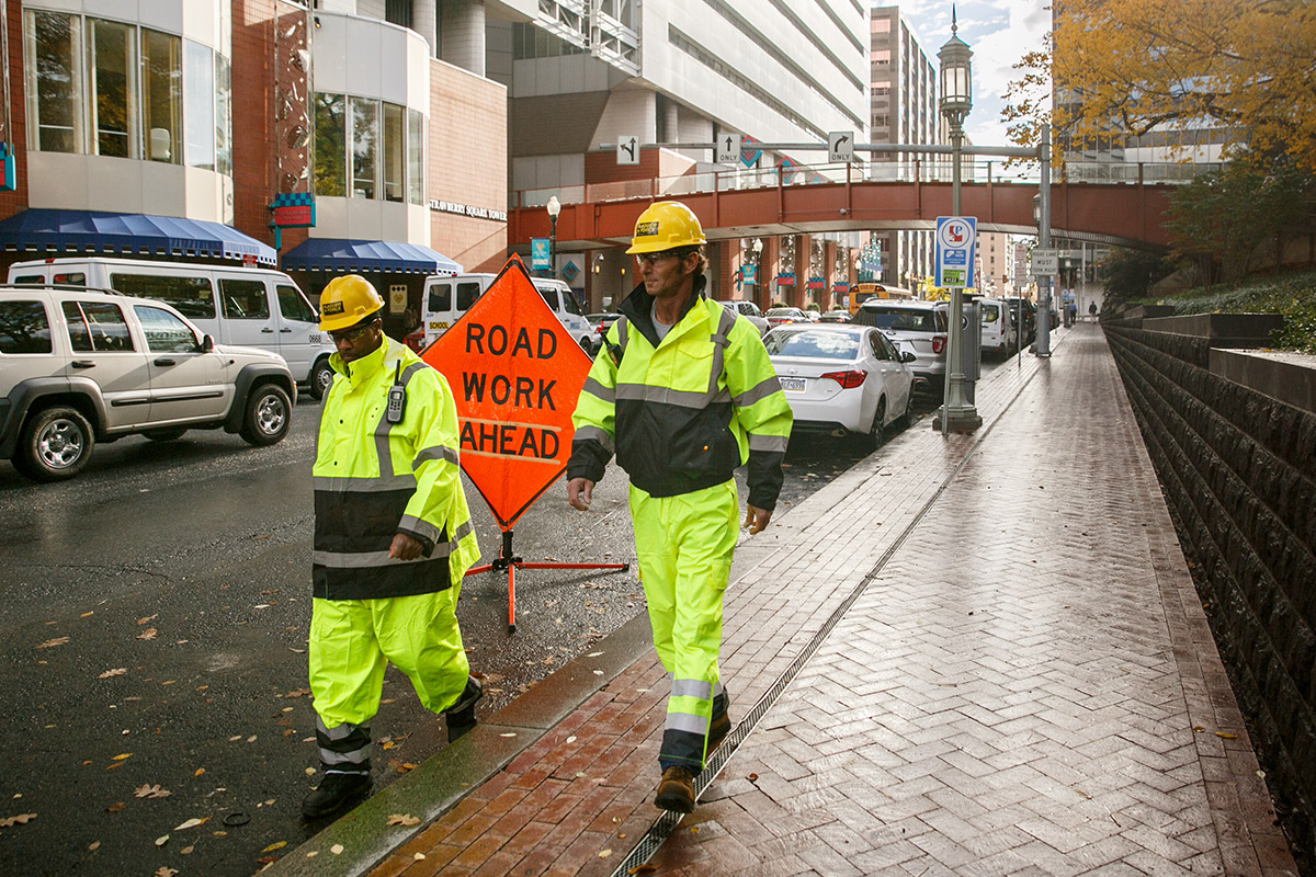 field-crew-employees-walking-down-city-sidewalk