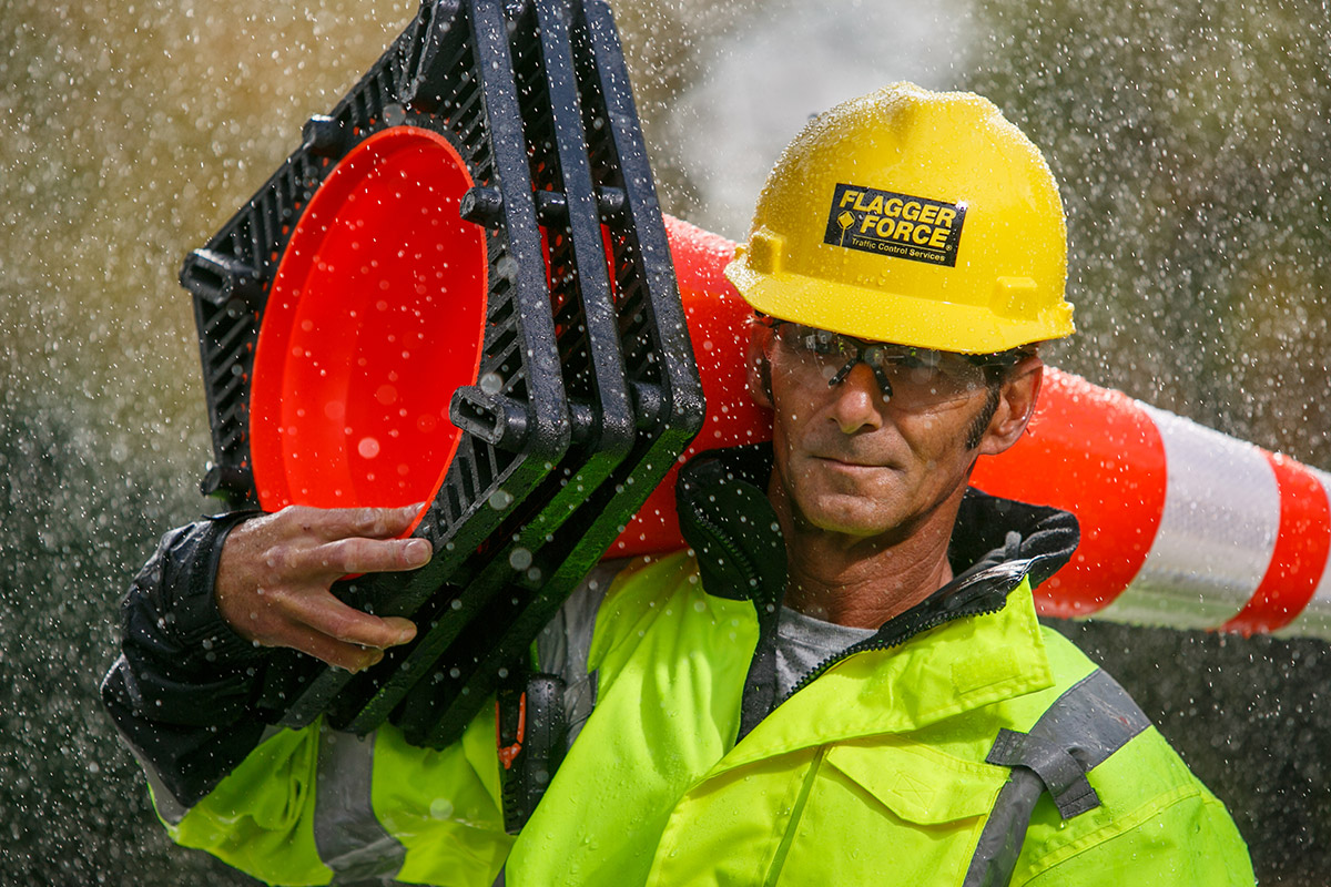 flagger-force-employee-carrying-cone-on-a-rainy-day