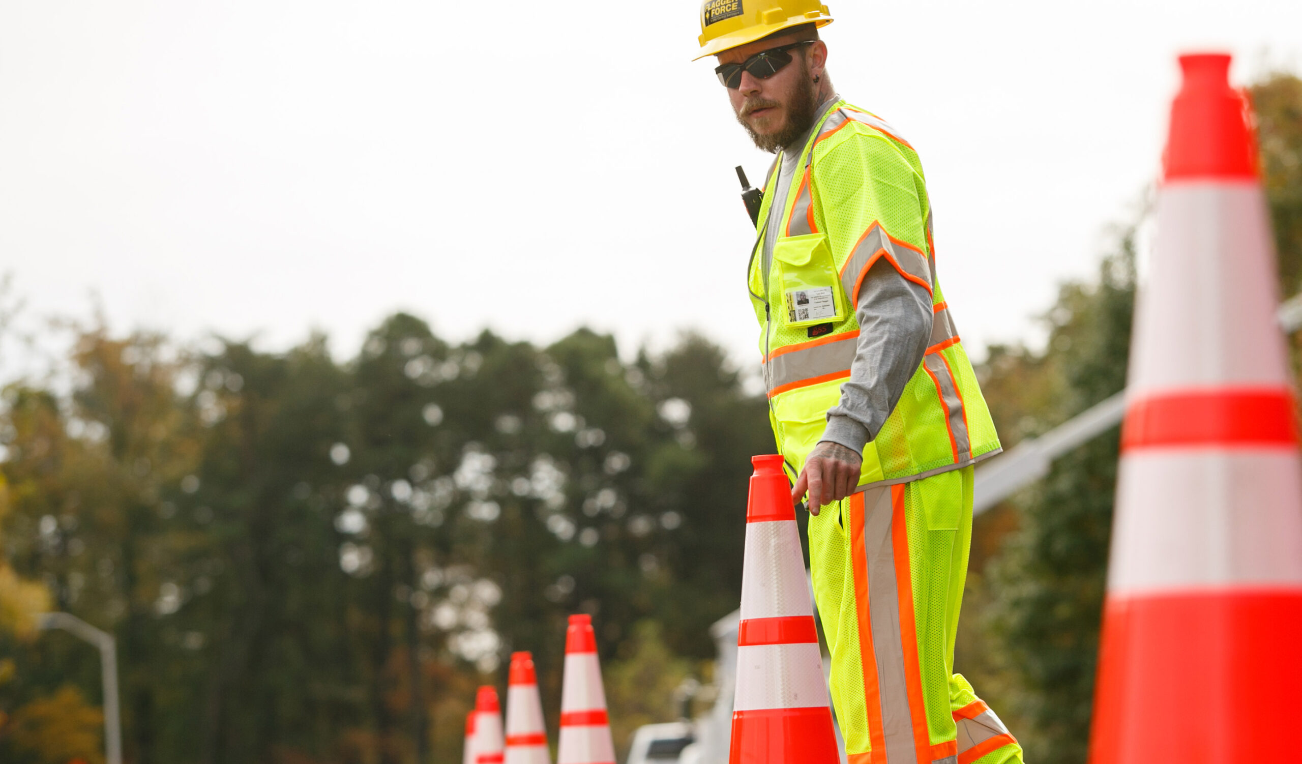 flagger-force-field-team-member-placing-cones-at-job-site-scaled