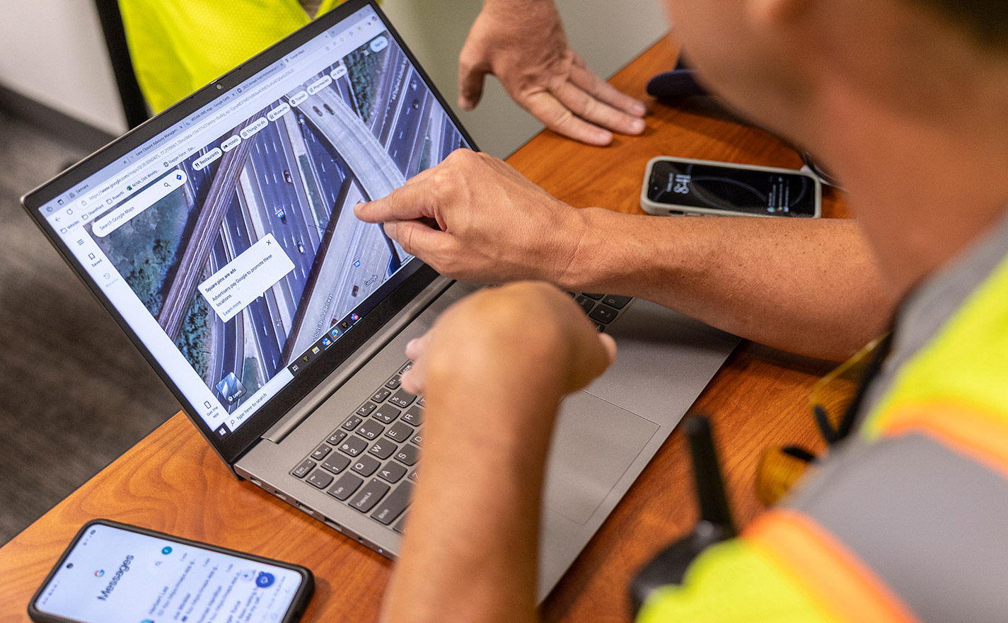 Flagger Force team members pointing to laptop screen