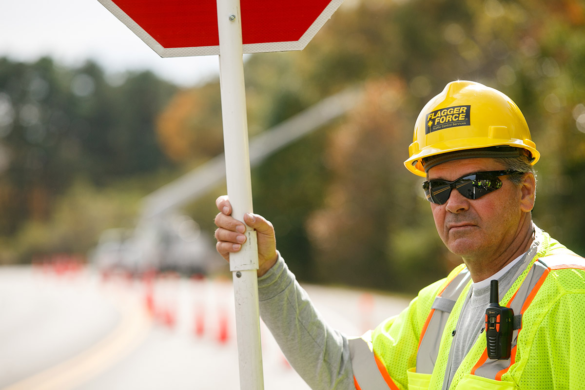 field-crew-member-holding-stop-sign