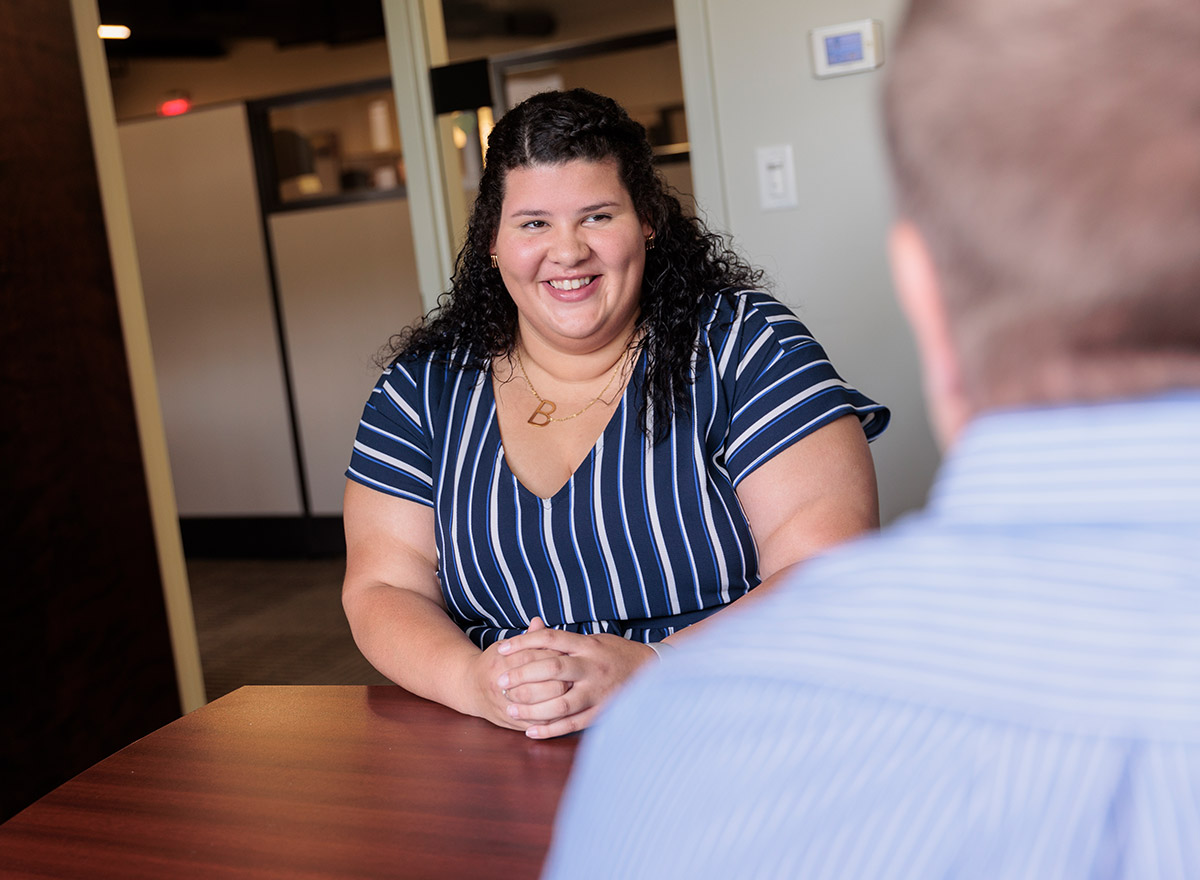 smiling-office-professional-sitting-at-desk
