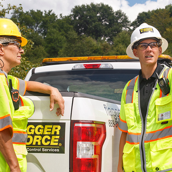 leadership_field-workers-leaning-on-flagger-force-truck-on-jobsite