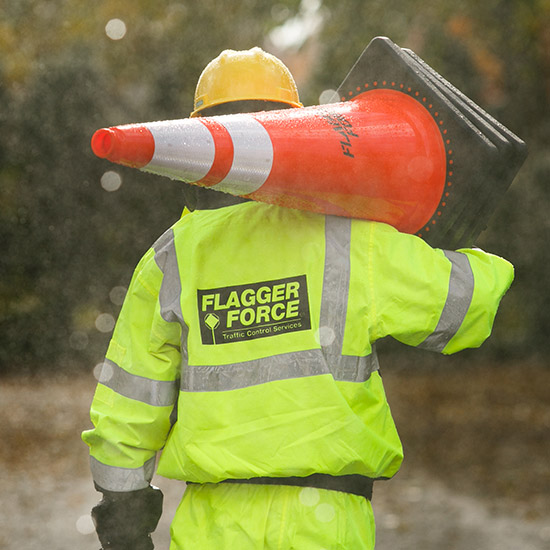 field-employee-holding-a-cone-in-high-visibility-gear