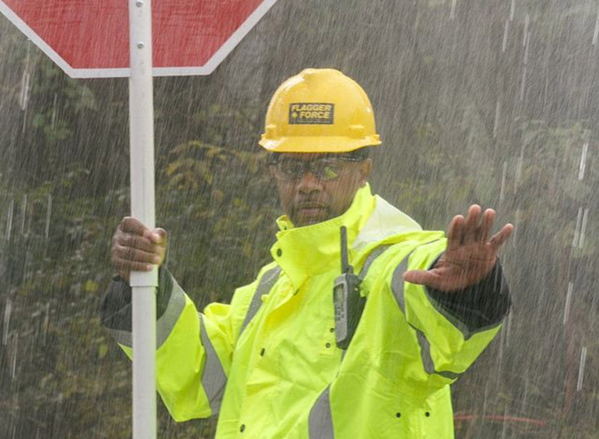 emergency-response_flagger-force-team-member-holding-stop-sign-with-hand-out-in-rain