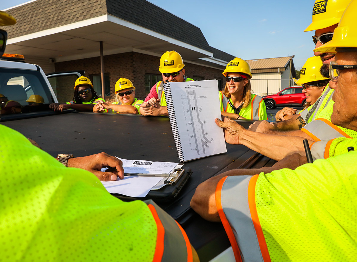 -tcps_field-team-discussing-jobsite-while-smiling