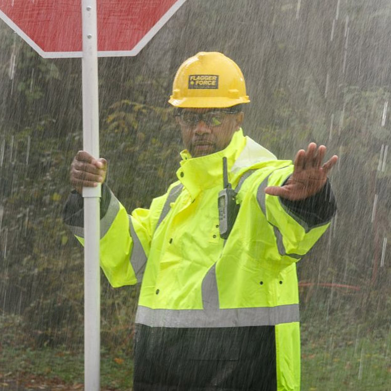 flagger-force-team-member-holding-stop-sign-with-hand-out-in-rain