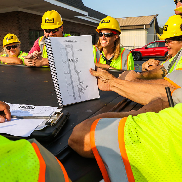 tcps_field-team-discussing-jobsite-while-smiling