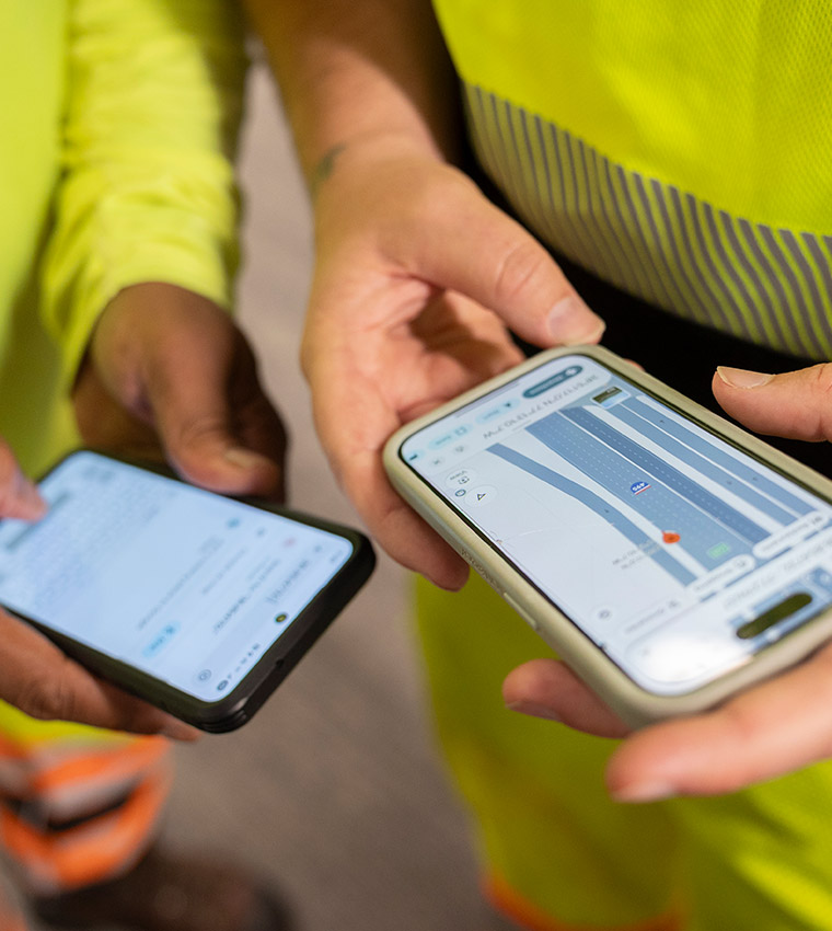 two-employees-using-technology-on-phones