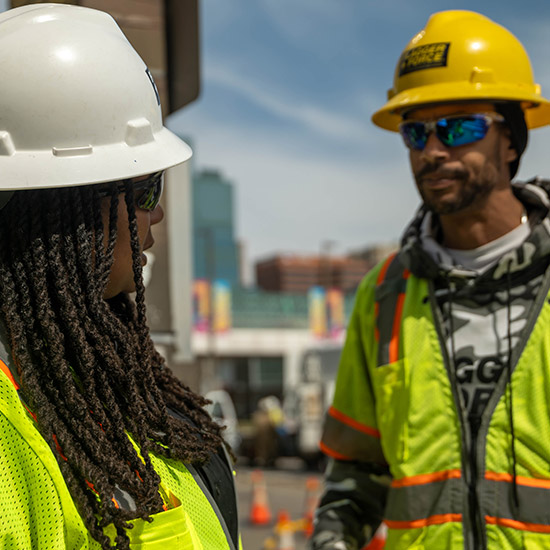 two-team-members-talking-onsite