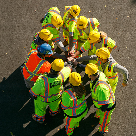 field-team-with-their-hands-in-for-encouragement