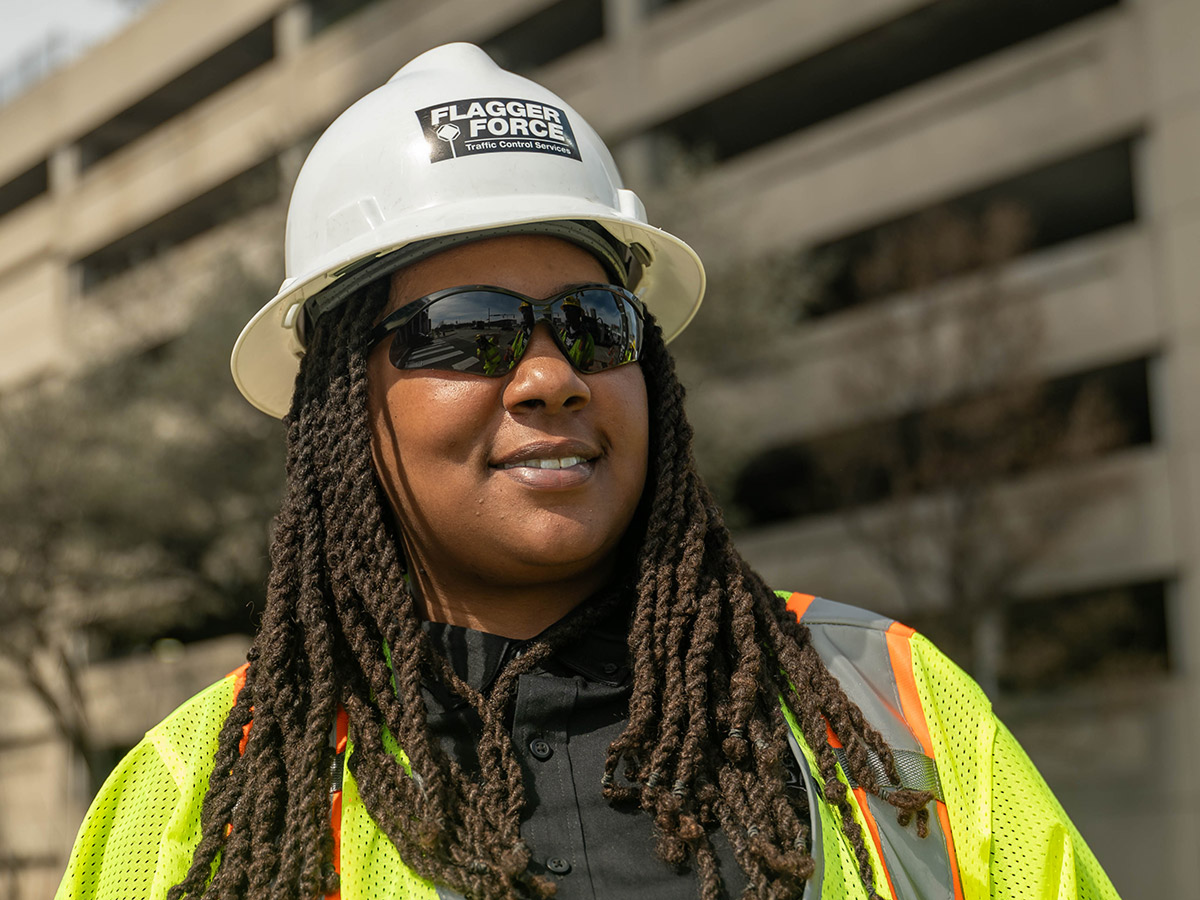 smiling-flagger-force-employee-with-high-visibility-gear