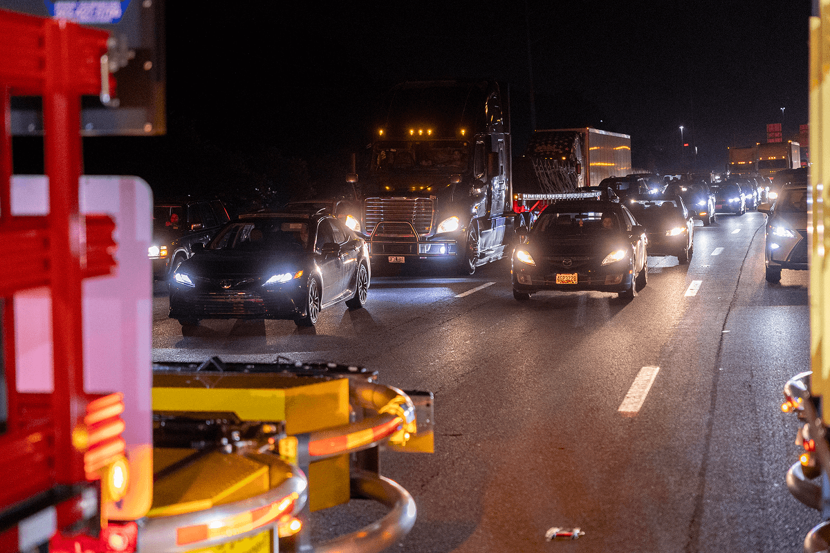 cars on a highway being directed safely through traffic at a special event